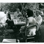 Group pictured at one of tables for the Diamond Jubilee Breakfast.  Man in dark coat facing camera (left side of photo) is Congressman John Rousselot. Others are not identified.