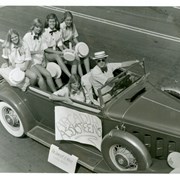 Vintage auto is filled with Arcadia Assisteens, a service club for teen-age girls.  None are identified.