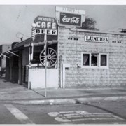 View of Herbert's Cafe from center of Alice Street right at intersection with Santa Anita. (Main fire house for Arcadia is presently located there.) There is a wagon wheel mounted near front.  It was owned by Herbert and Catherine Schmidt from 1939-1957.  See Arcadia VF-Restaurants, bars, etc. for further information regarding special days and how they were celebrated here.