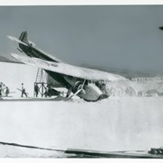 A two-engined plane is seen crashed nose down into "snow".  There are about 11 motion picture employees working about.  One can see expanses of "snowy" terraine, with San Gabriel Mountains showing above sets.  Printed on plane are words: PIERCE+RONDELLE ANTARCTIC EXPEDITION.  Ray Ramuz, who lived across from Arcadia County Park area where this was filmed, said that the "snow" was bleached corn flakes.