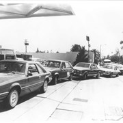 Group of cars waiting in line to buy gasoline at local service station. During the Iranian Revolution, Iran had ceased its export of oil causing prices to skyrocket. We were caught in a crunch that became a regular part of our lives. It appears to be a Mobil service station in Arcadia. The first four cars in line are the: brand new Ford Mustang (1979 model), Chevrolet Chevette (?), Chevrolet Monte Carlo, and Chevrolet Camaro.