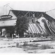 Cinemaland seen here being demolished during 1977.  In this view showing grass growing in former parking lot, one can see that theater had been closed for several years.