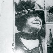 Clara Baldwin portrait from a newspaper.  She is shown in later years, wearing a felt hat that has a feather decoration. She is also wearing beads in a choker style.